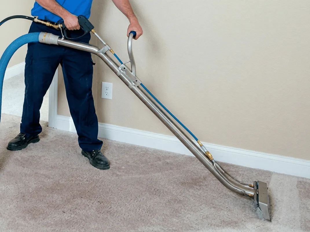 Professional operating a liquid removal machine on a carpeted floor in Aurora, IL